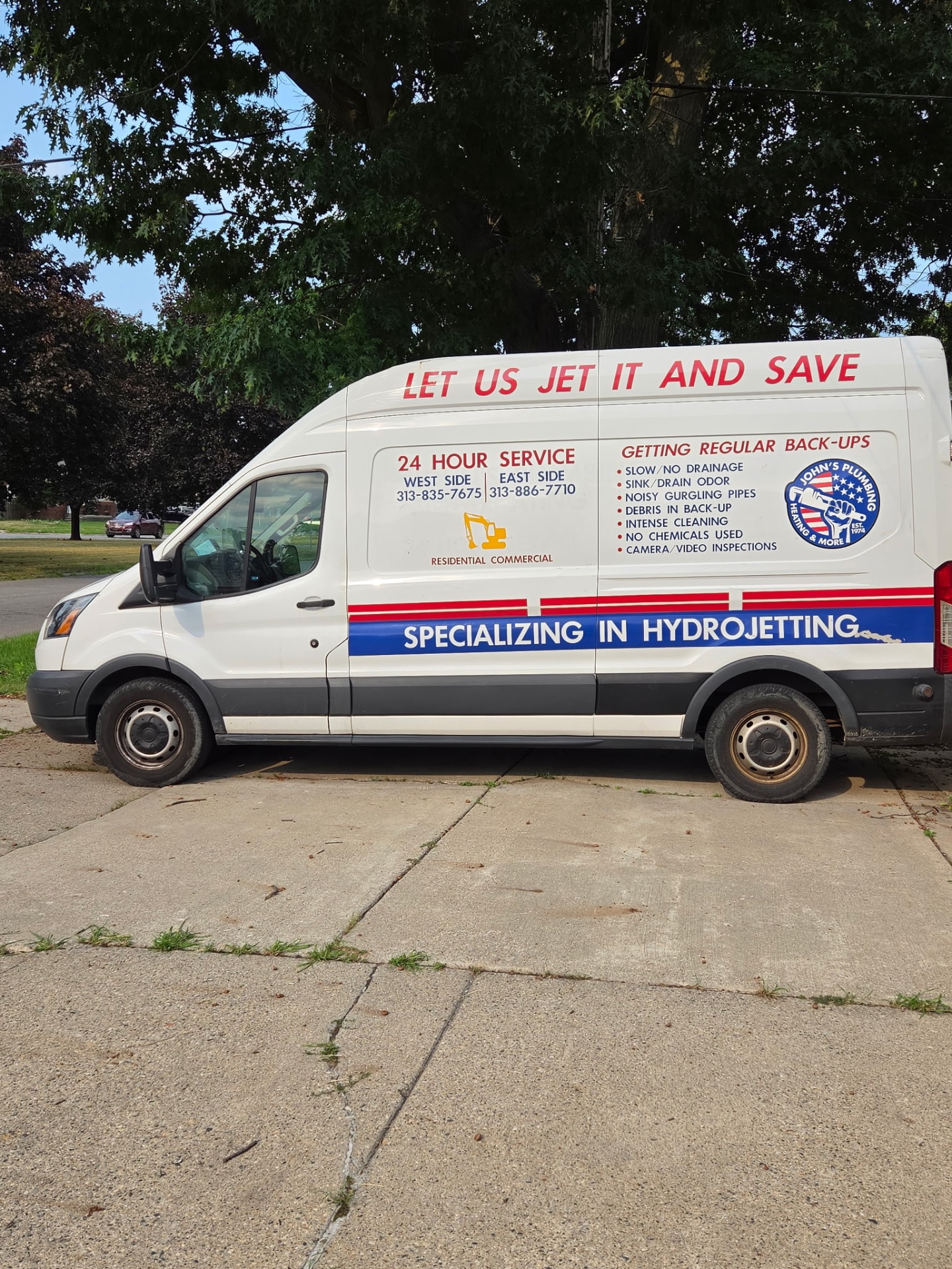 John's Plumbing Heating and More hydro-jetting van lettered "Let us jet it and save"